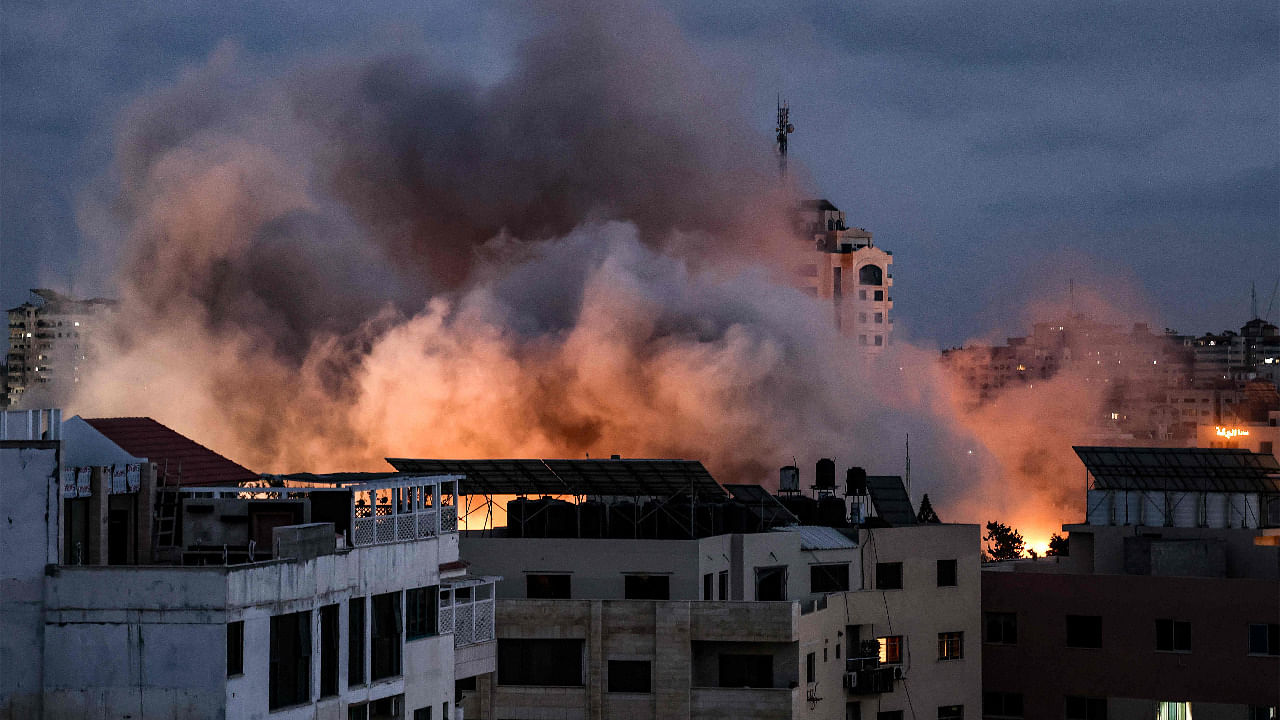 Smoke billows above buildings during an Israeli air strike on Gaza City. Credit: AFP Photo