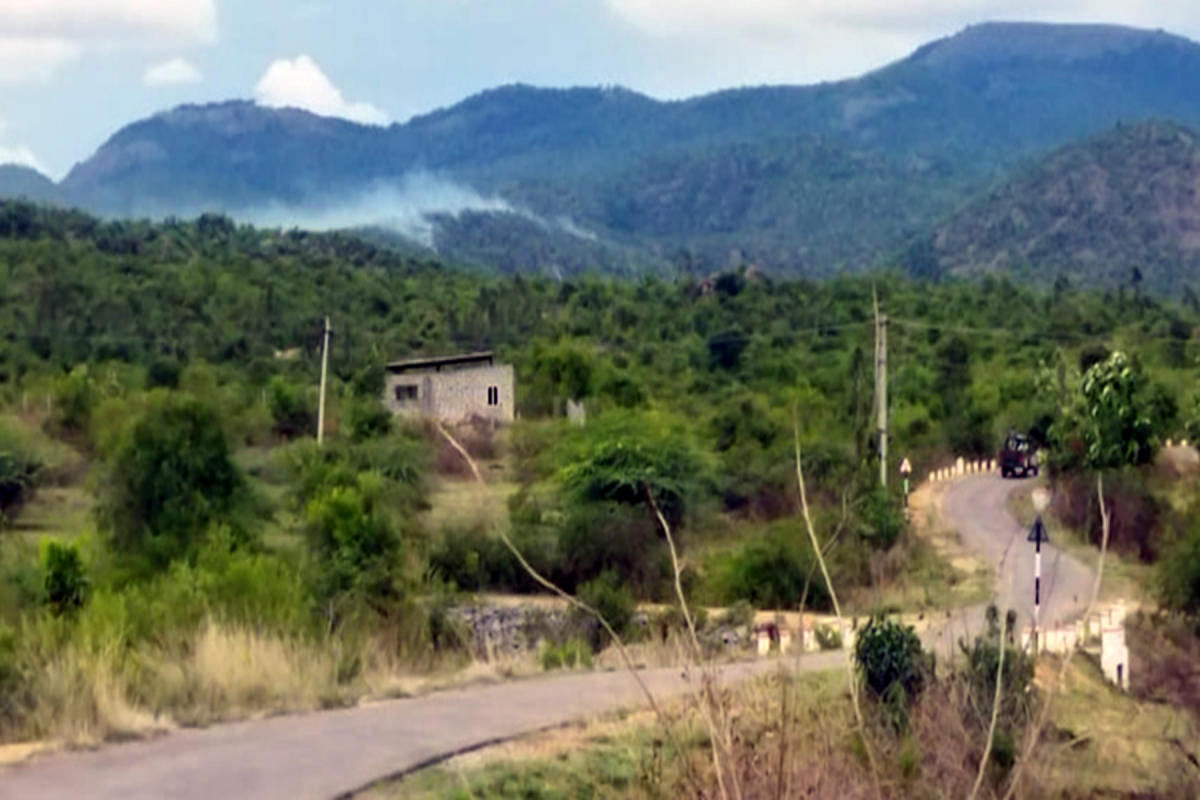 Smoke emanates from Vibhutigudda at Biligiri Rangana Betta region, Yalandur taluk, Chamarajanagar district, on Friday. DH PHOTO