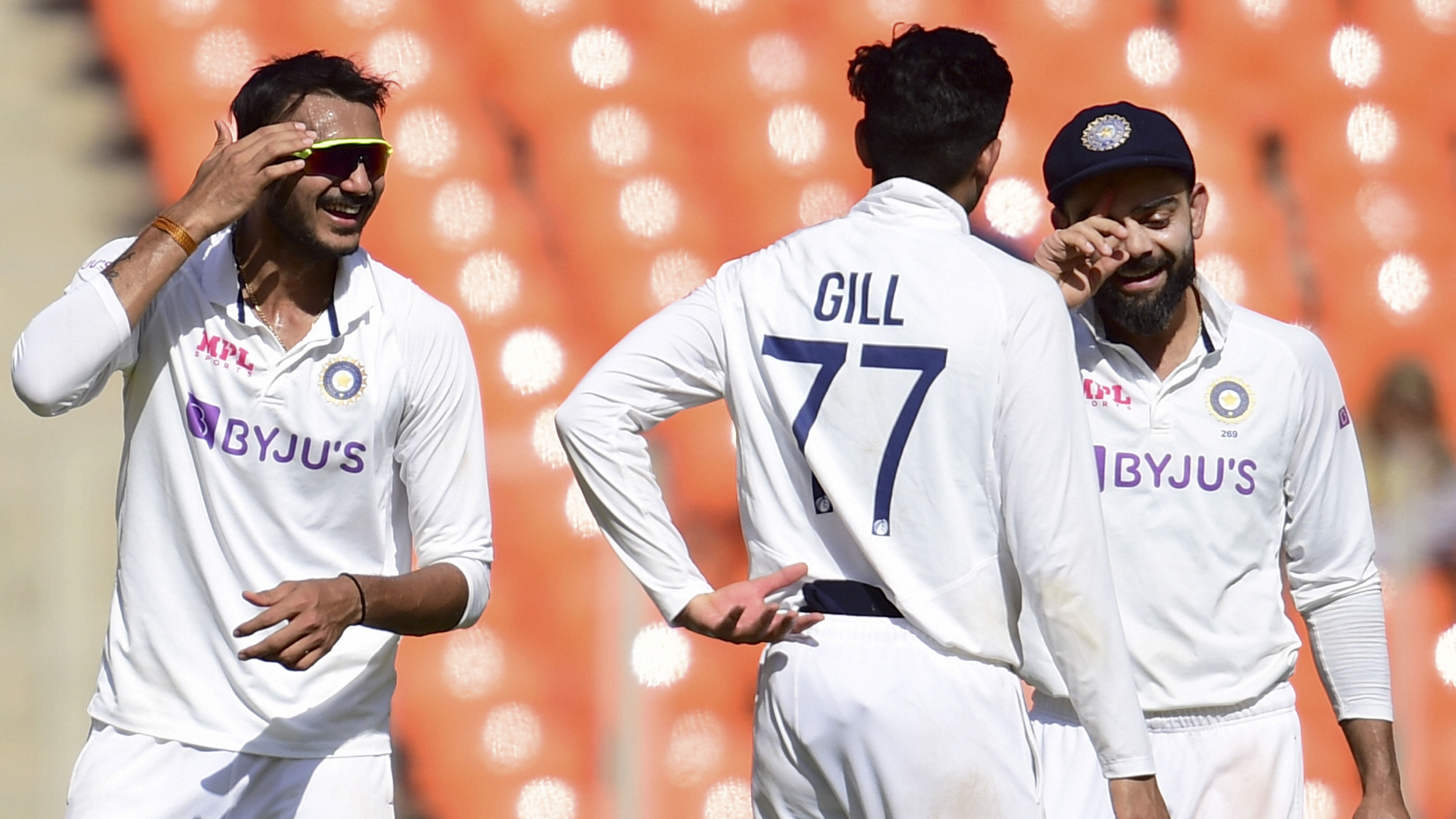  Indian captain Virat Kohli celebrates with bowler Axar Patel (L) and player S Gill (C) against England in a Test series in Ahmedabad. Credit: PTI Photo