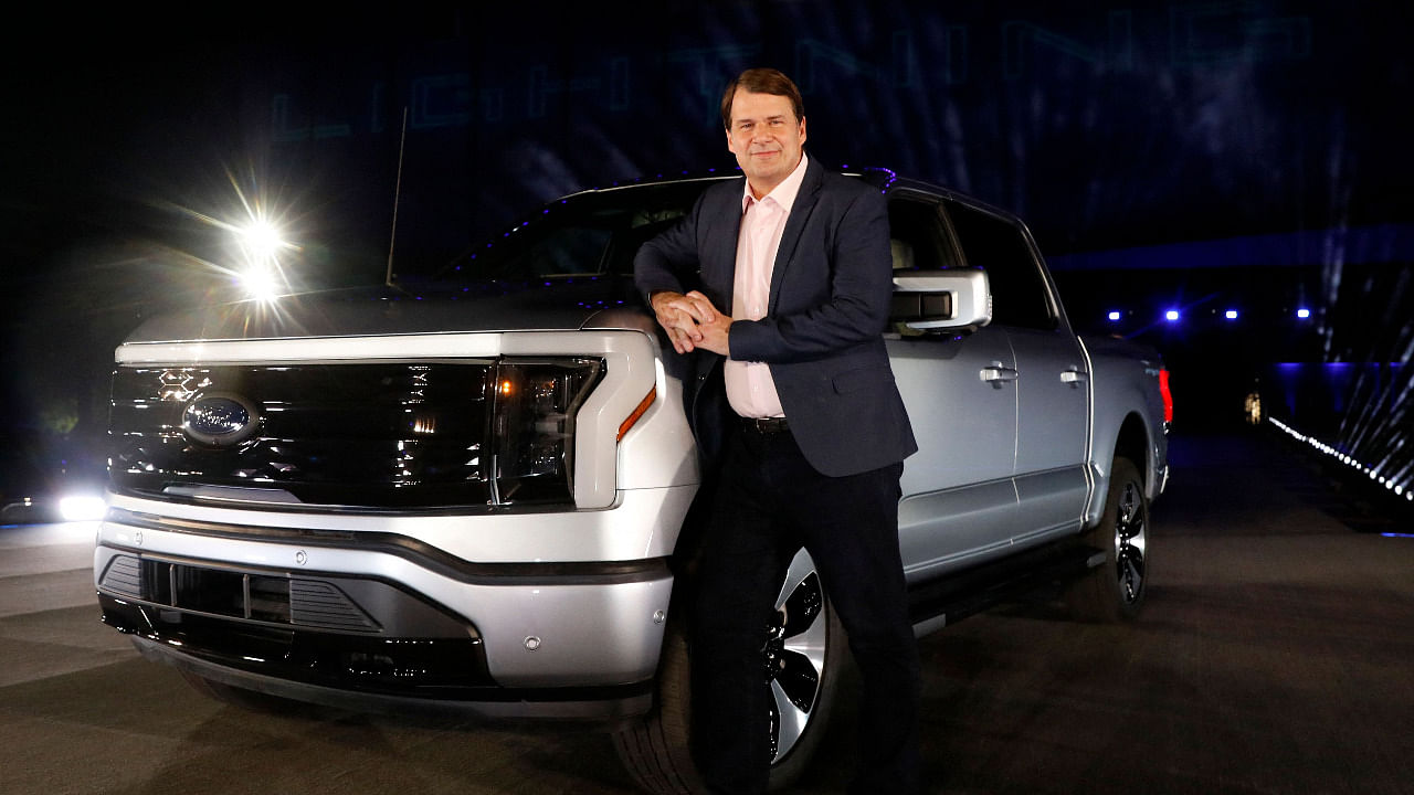 Ford Motor Company's chief executive officer Jim Farley poses next to the newly unveiled electric F-150 Lightning. Credit: AFP Photo