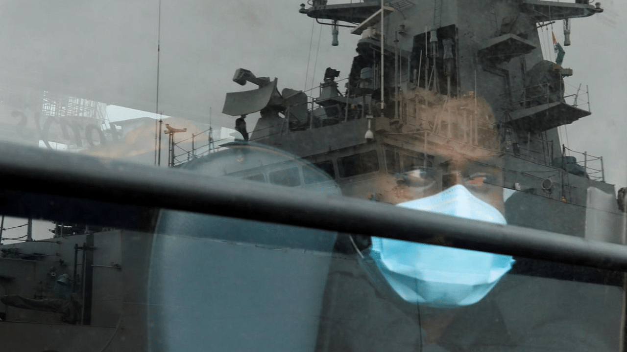 A man who was stranded at sea aboard Barge P305 due to Cyclone Tauktae looks out of a bus window after he was rescued by the Indian Navy. Credit: Reuters Photo