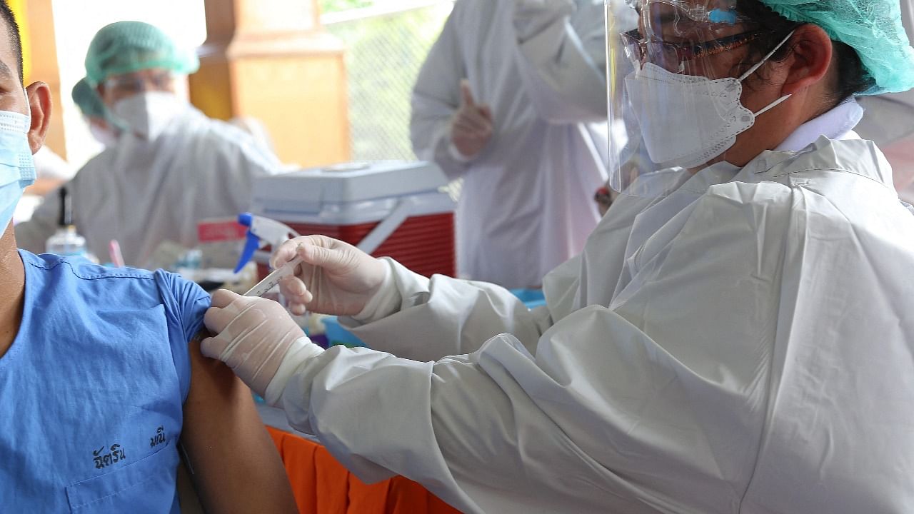 A health worker administers a dose of vaccine for the Covid-19 coronavirus to an inmate at Minburi Remand Prison in Bangkok. Credit: AFP Photo/Thailand Ministry of Justice
