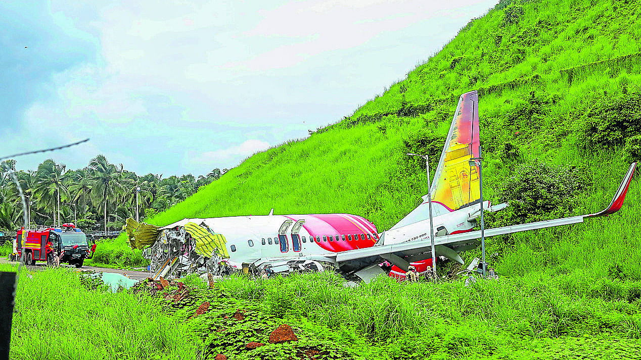 Mangled remains of an Air India Express flight, en route from Dubai, after it skidded off the runway while landing on Friday night, at Karippur in Kozhikode. Credit: PTI Photo