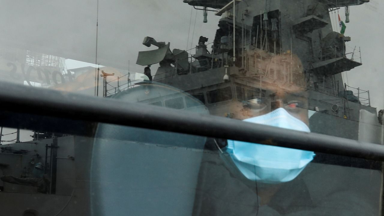 A man who was stranded at sea aboard Barge P305 due to Cyclone Tauktae looks out of a bus window after he was rescued by the Indian Navy. Credit: Reuters File Photo