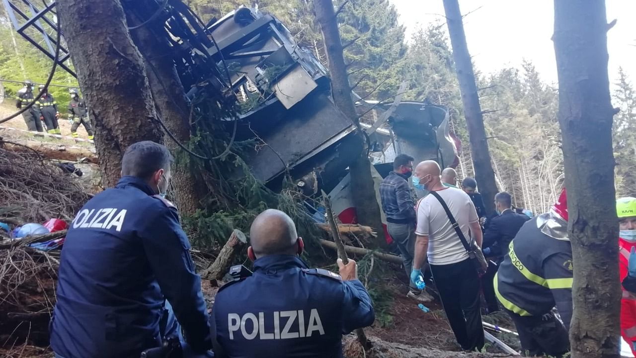 Police and rescue service members are seen near the crashed cable car after it collapsed in Stresa, near Lake Maggiore, Italy May 23, 2021. Credit: Reuters Photo