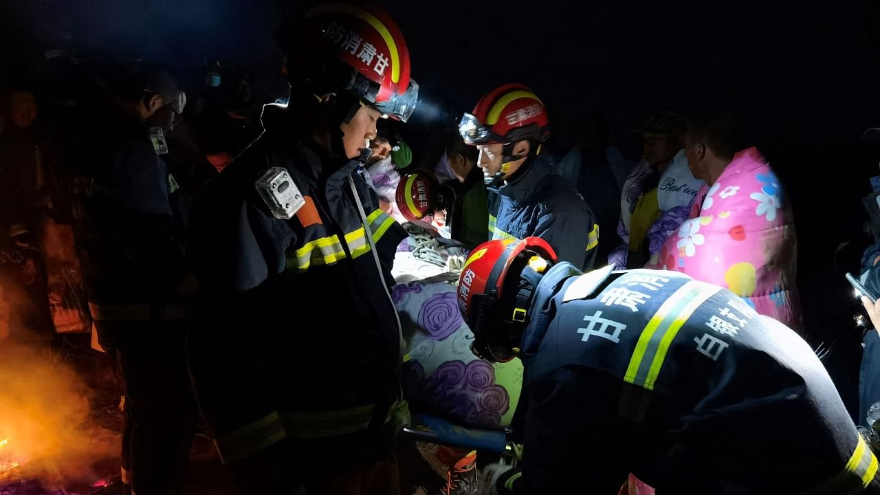 This photo taken on May 22, 2021 shows rescuers assisting people who were competing in a 100-kilometre cross-country mountain race when extreme weather hit the area, leaving at least 20 dead, near the city of Baiyin in China's northwestern Gansu province. Credit: AFP Photo