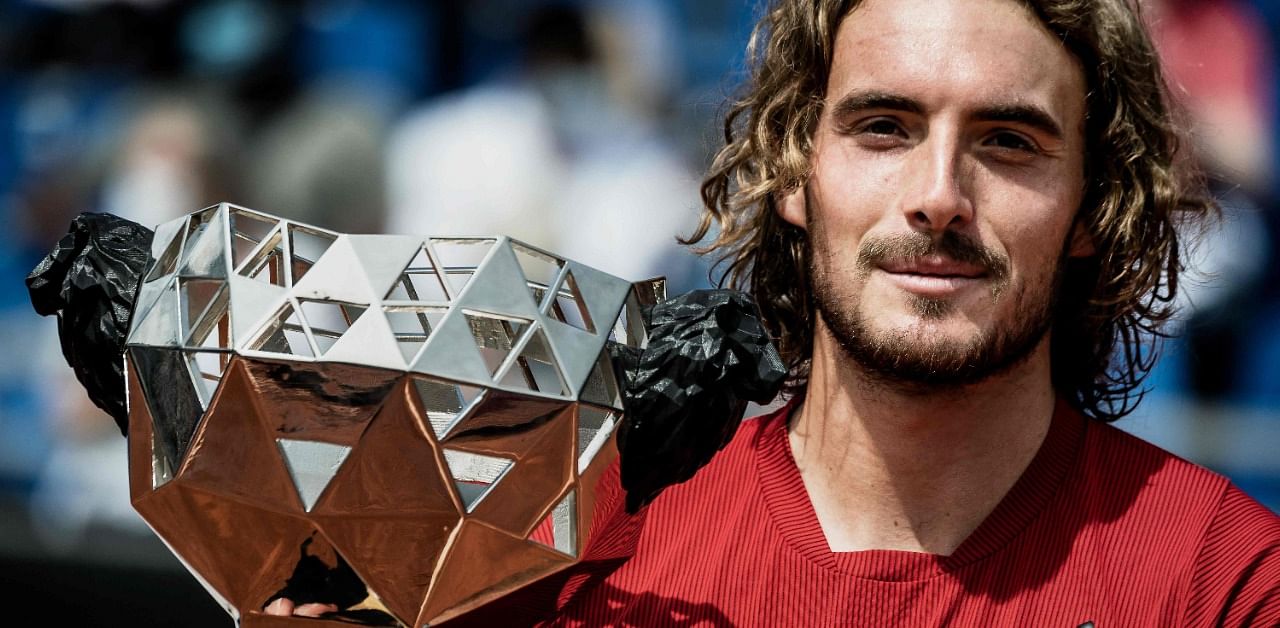Tsitsipas poses with the trophy after winning the ATP 250 Lyon Open. Credit: AFP Photo