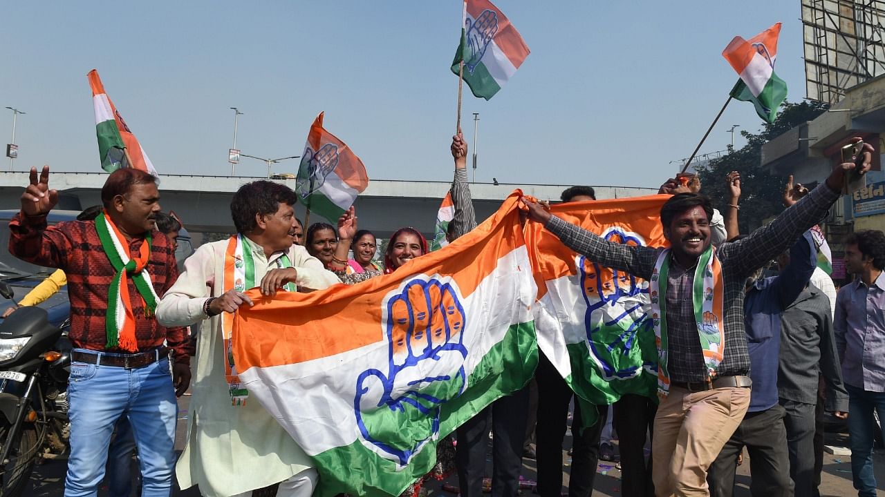 Indian Congress party supporters hold a Congress party flag as they celebrate in Ahmedabad on December 11, 2018. Representative Image. Credit: PTI File Photo