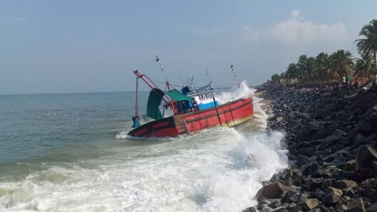 A fishing boat accidentally hit the shore at Kodi near Ullal in Dakshina Kannada district in the wee hours of Sunday. Credit: DH Photo