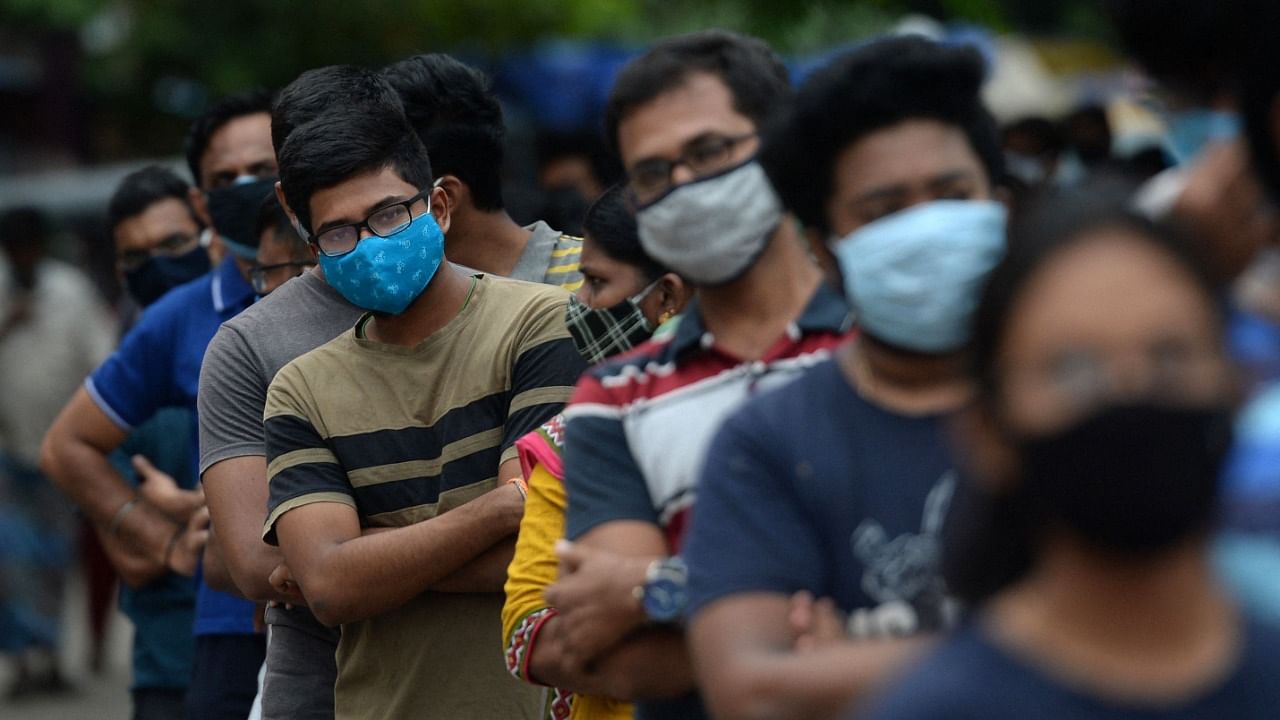 People wait to get themselves inoculated with the dose of Covishield Covid-19 coronavirus vaccine at a vaccination camp in a residential area in Chennai on May 24, 2021. Credit: AFP Photo