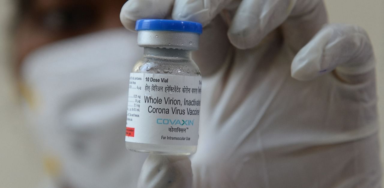 A medical worker displays a vial of Covaxin. Credit: AFP Photo