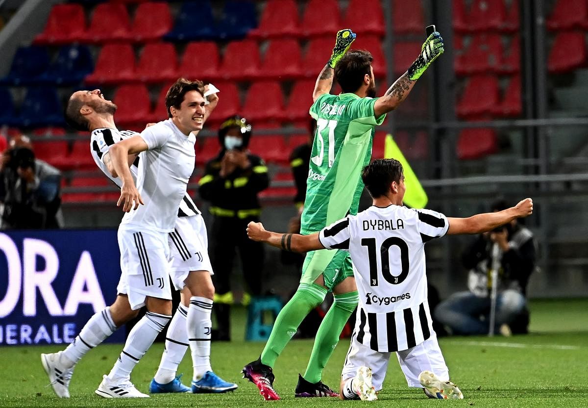  Juventus' Italian defender Leonardo Bonucci, Juventus' Italian forward Federico Chiesa, Juventus' Italian goalkeeper Carlo Pinsoglio and Juventus' Argentine forward Paulo Dybala celebrate after securing their qualification for the Champions League at the end of the Italian Serie A football match Bologna vs Juventus. Credit: AFP Photo