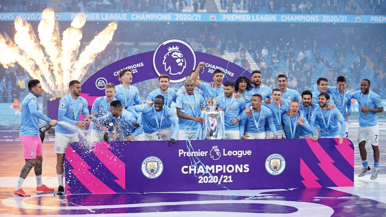 Manchester City's Brazilian midfielder Fernandinho holds the Premier League trophy during the award ceremony as the team celebrates. Credit: AFP Photo