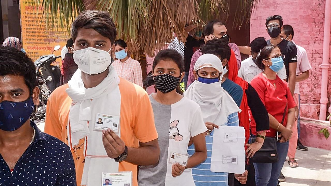 People stand in a queue to receive a dose of Covid-19 vaccine in Varanasi. Credit: PTI Photo