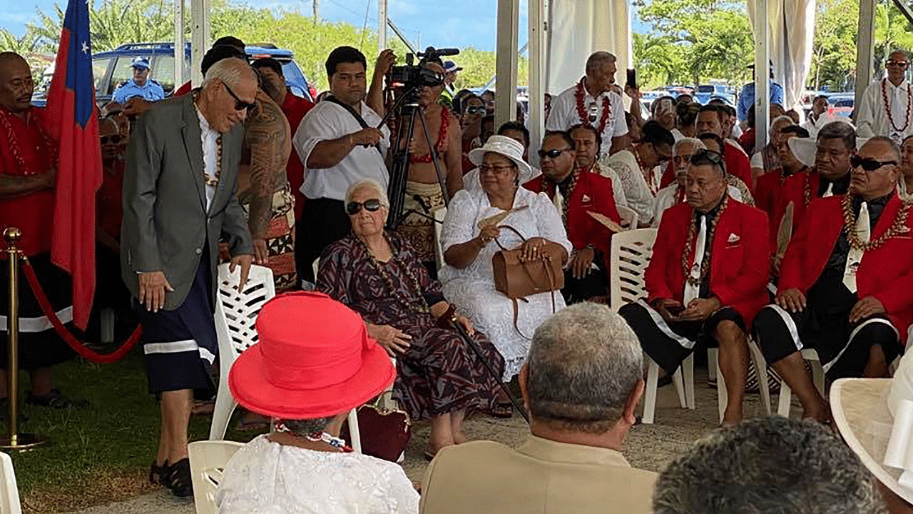 Members of the judiciary parliament wait near parliament in Apia on May 24, 2021, after they were locked out of the Pacific nation's parliament. Credit: AFP Photo