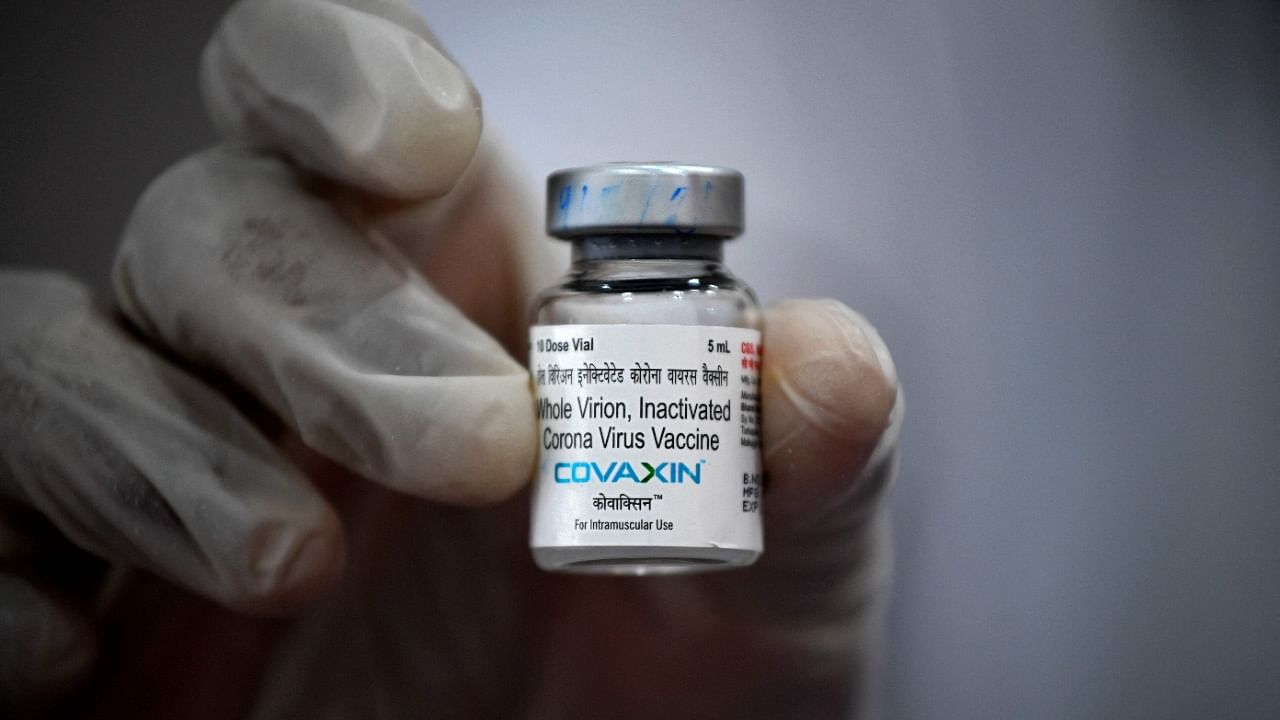 A medical worker holds a vial of the Covaxin Covid-19 vaccine. Credit: AFP Photo