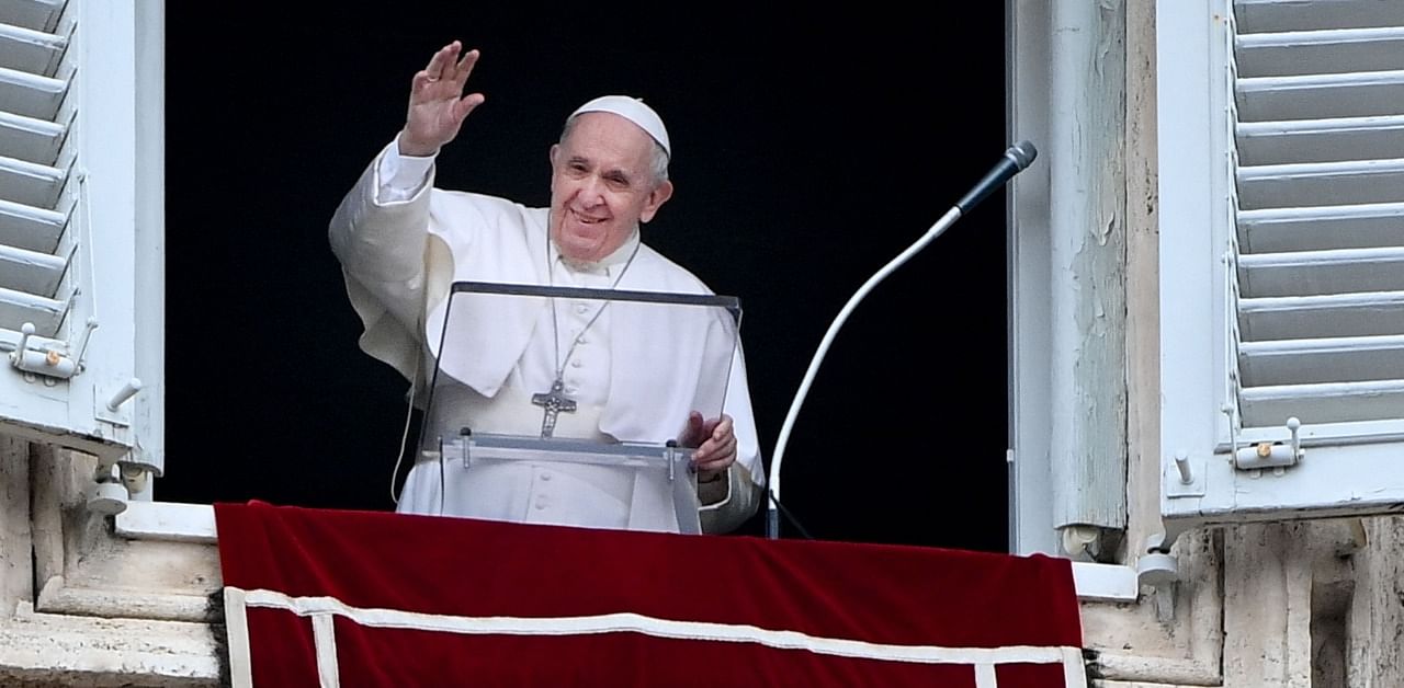 Pope Francis waves during the weekly Angelus prayer. Credit: AFP Photo