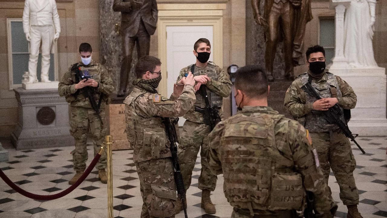 In this file photo taken on February 04, 2021 member of the National Guard tour Statuary Hall on Capitol Hill in Washington, DC. Credit: AFP Photo