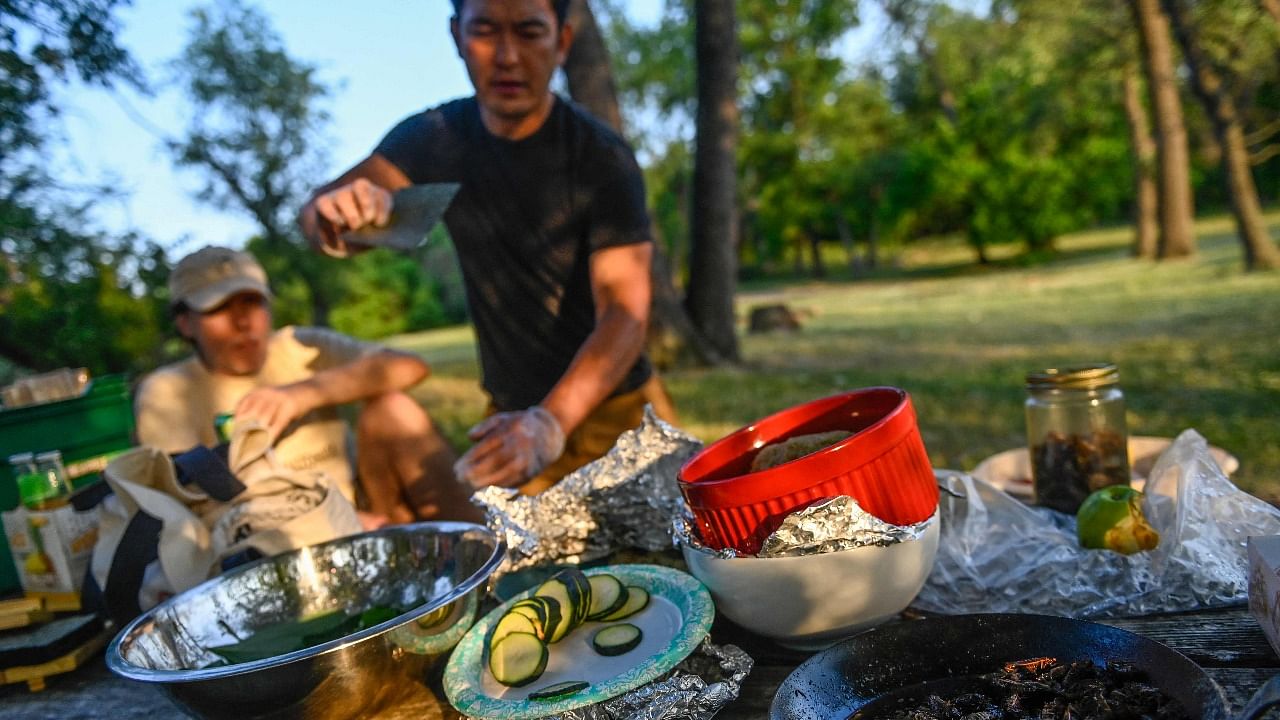 Chef Bun Lai prepares to make fried cicada sushi at Fort Totten Park in Washington. Credit: AFP Photo