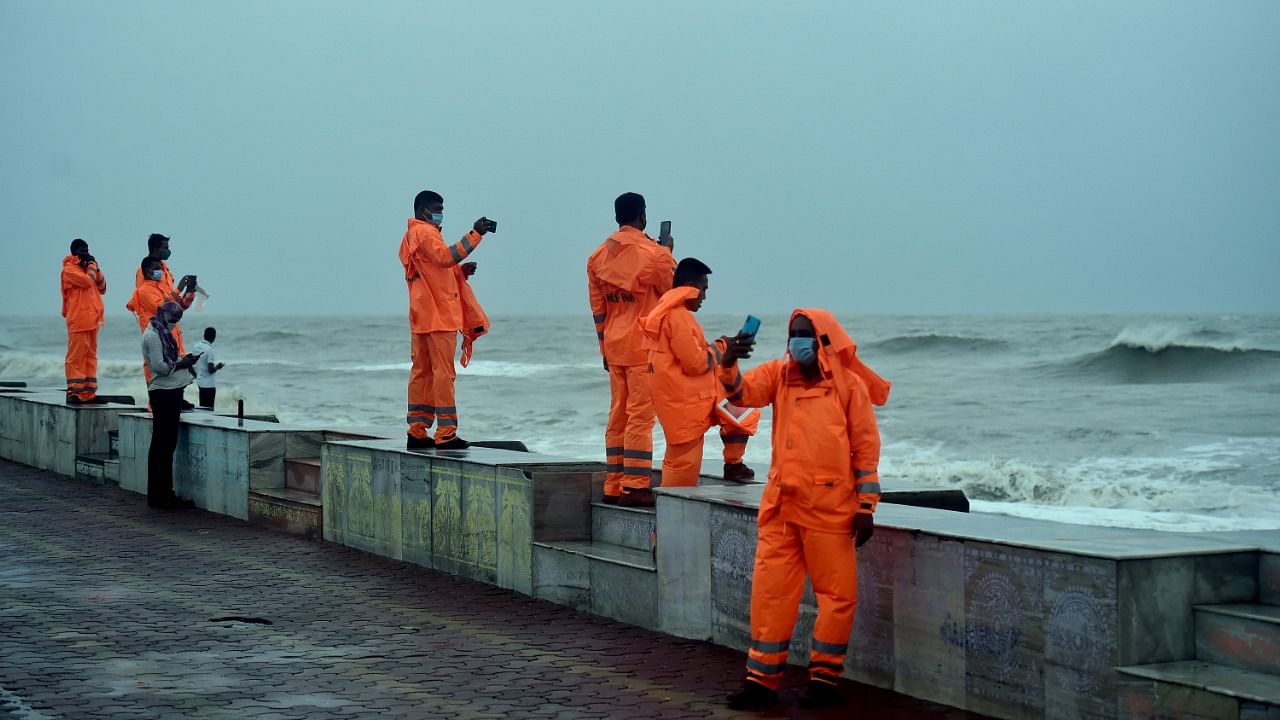 East Midnapore: Members of NDRF team click pictures from the beach of a rough waves in the Bay of Bengal ahead of Cyclone 'Yaas' landfall, at Digha in East Midnapore district, Tuesday, May 25, 2021. Credit: PTI Photo