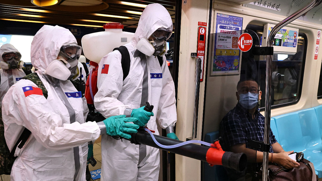 Soldiers in protective suits disinfect a metro station following a surge of coronavirus disease in Taipei. Credit: Reuters Photo