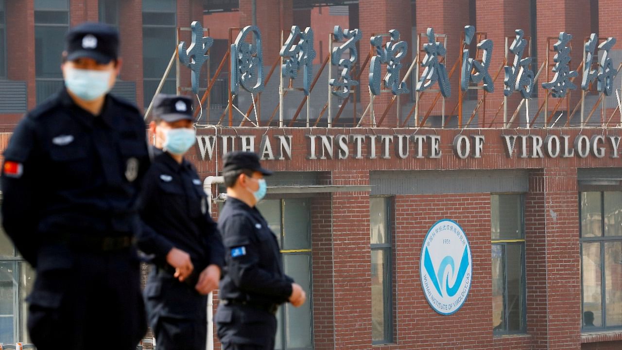 Security personnel keep watch outside the Wuhan Institute of Virology during the visit by the World Health Organization (WHO) team tasked with investigating the origins of the coronavirus. Credit: Reuters File Photo