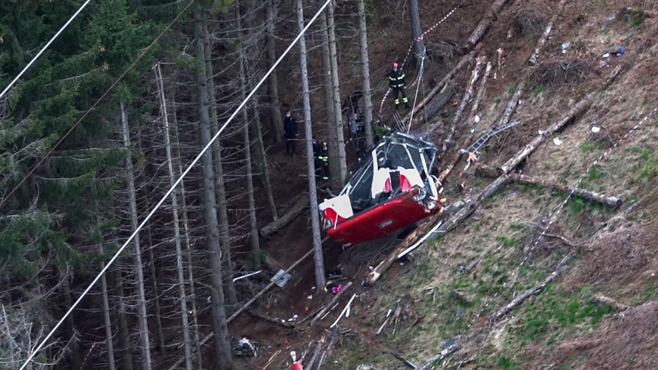 A photo grabbed from an aerial video taken and handout on May 23, 2021 by The Italian Firefighters "Vigili del Fuoco" shows rescuers working by a cable car that crashed to the ground in the resort town of Stresa on the shores of Lake Maggiore in the Piedmont region. Credit: AFP Photo