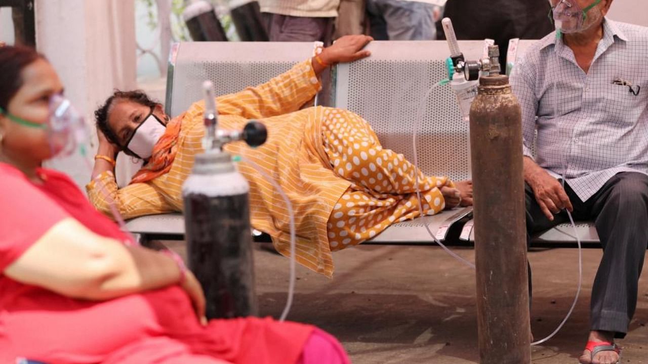 Patients on oxygen support, wait outside the Covid-19 facility of the Chest Disease Hospital in Jammu, Saturday, May 8, 2021. Credit: PTI Photo