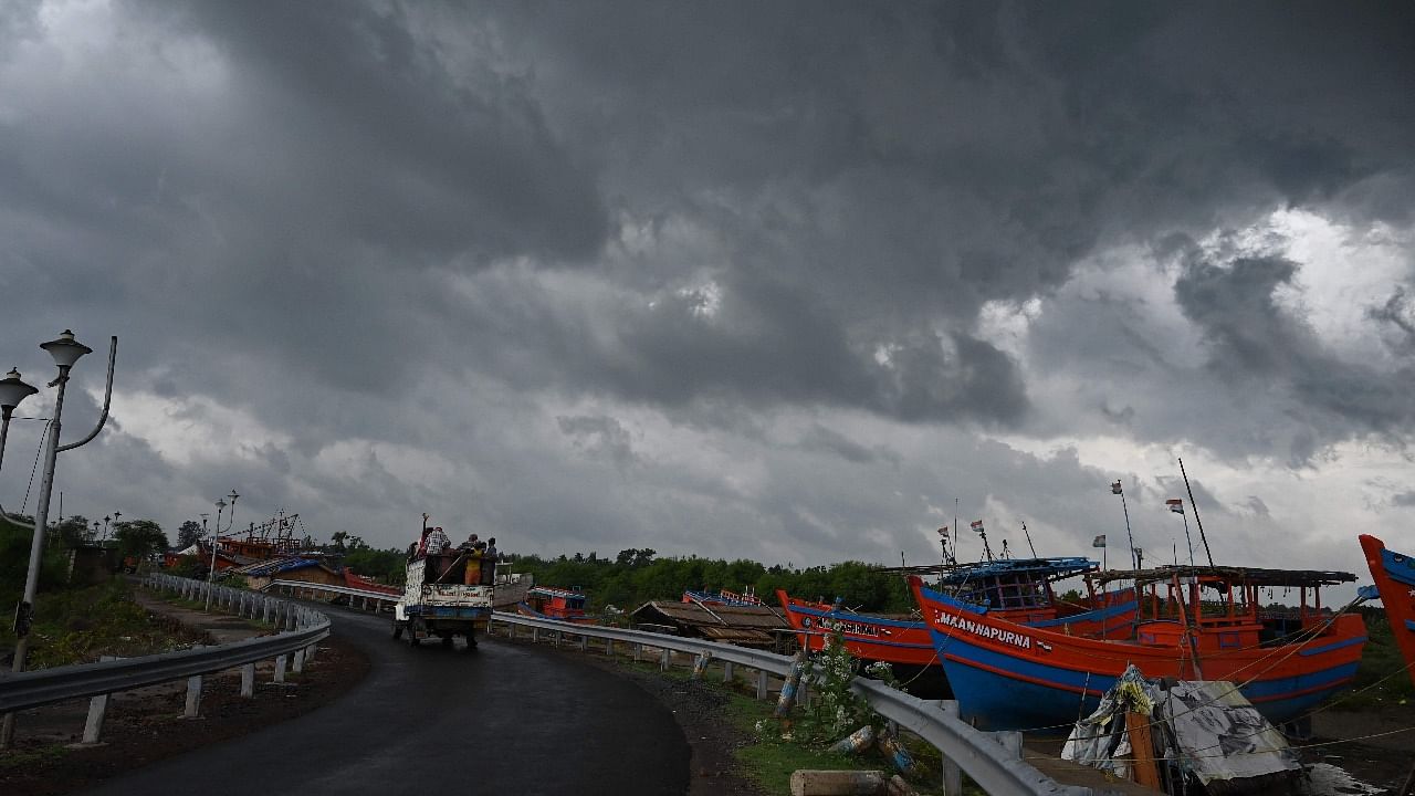 Dark clouds loom over fishing boats moored as Cyclone Yaas barrels towards India's eastern coast in the Bay of Bengal where is expected to make a landfall tomorrow, in Digha some 190 KM from Kolkata. Credit: AFP Photo