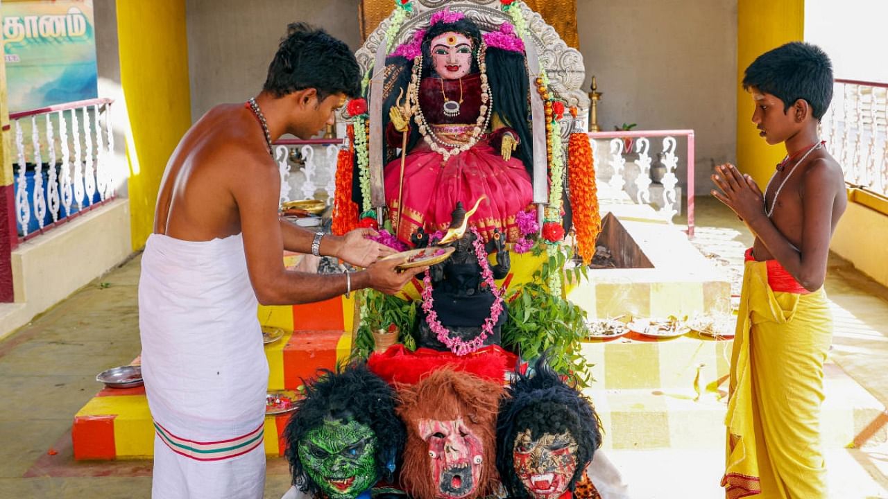 Devotees pray at a newly built temple dedicated to ‘Goddess Corona Devi', in the wake of second wave of coronavirus, at Irugar in Coimbatore. Credit: PTI Photo