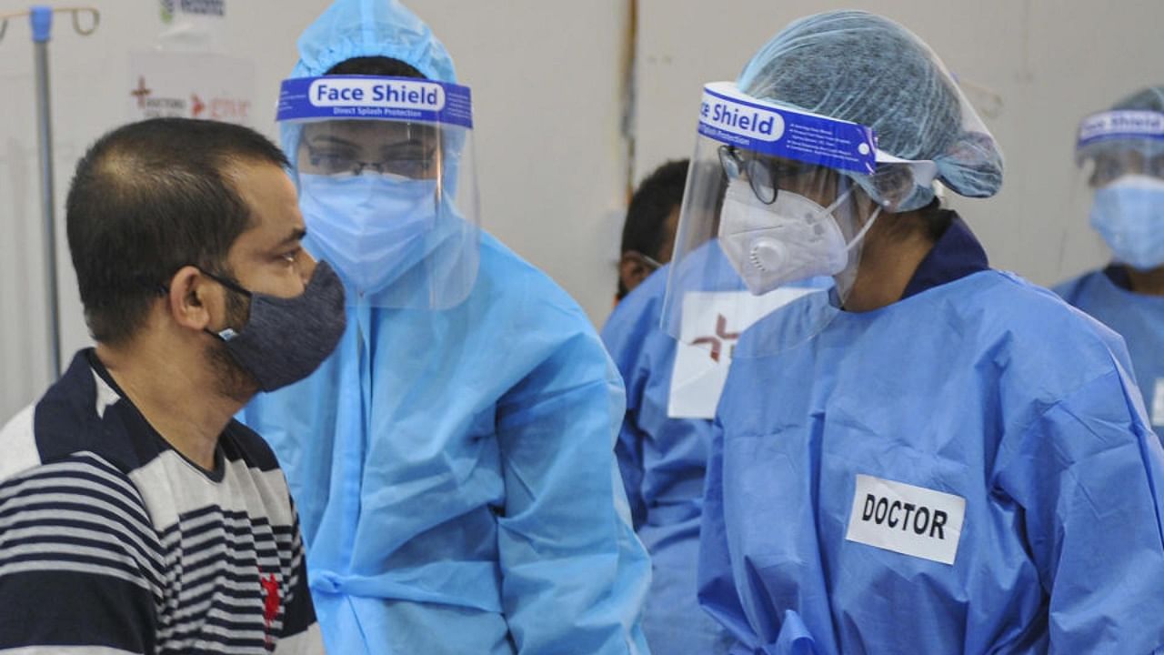 Health workers wearing PPE kits attend to Covid-19 patients at a newly set up temporary hospital at Tau Devi Lal Stadium in Gurugram, Thursday, May 27, 2021. Credit: PTI Photo