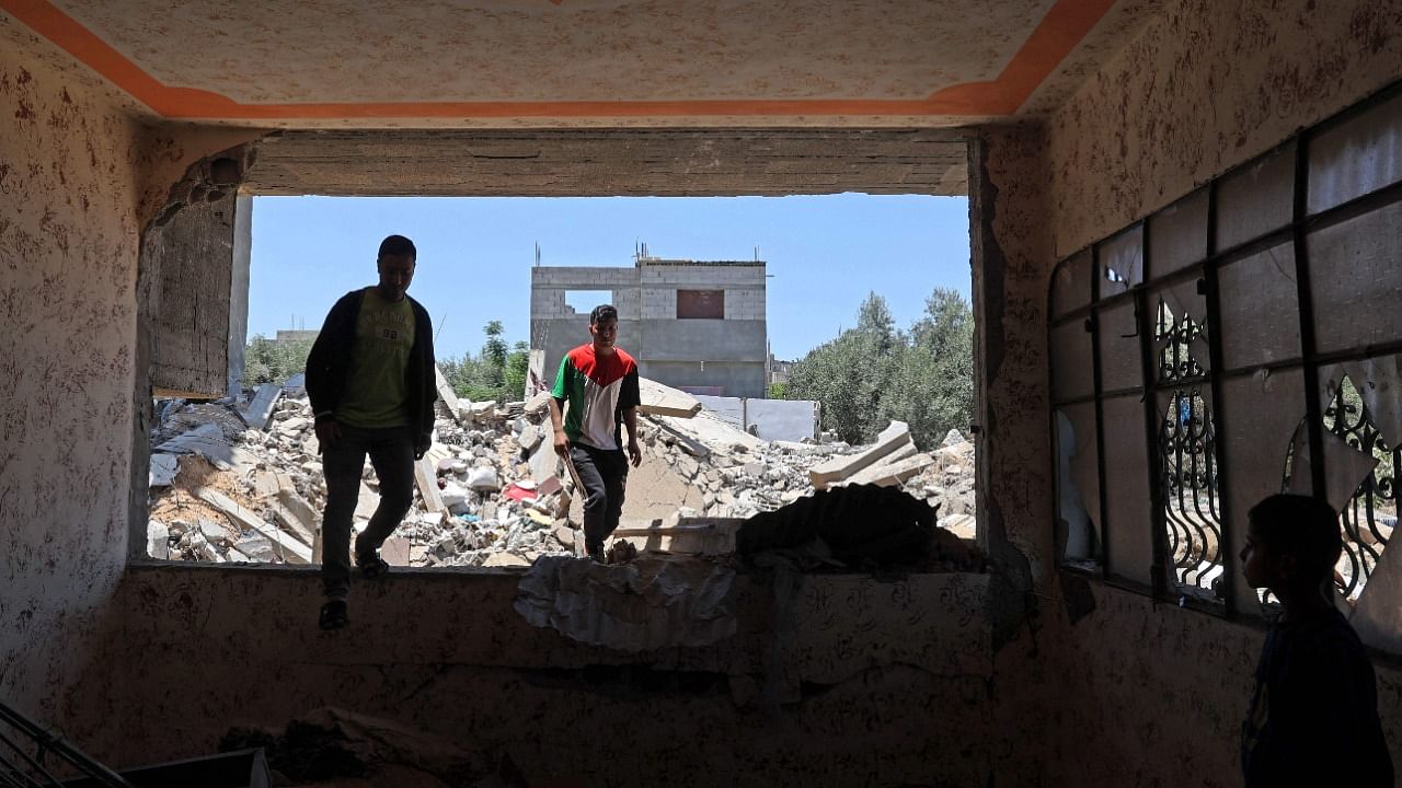 Palestinians inspect their house which was recently damaged by Israeli strikes in Khan Yunis in the southern Gaza Strip. Credit: AFP Photo