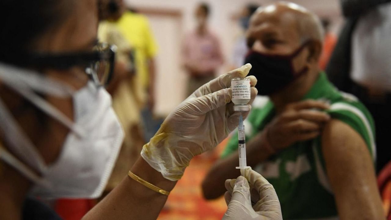 A health worker prepares to inoculate a man with a dose of a Covid-19 vaccine in Amritsar on Thursday. Credit: AFP Photo