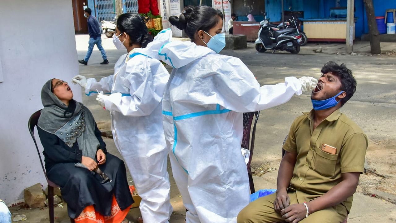 Healthcare workers check people for Covid-19. Credit: PTI Photo