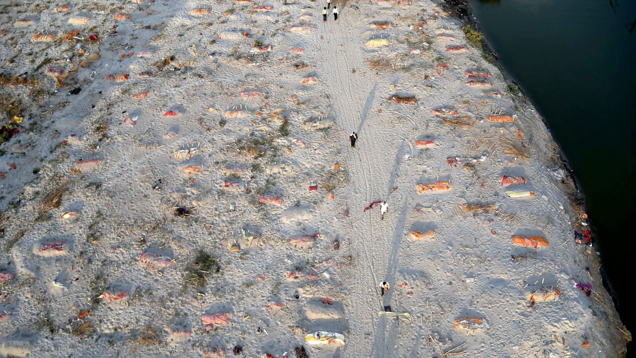 Bodies of the deceased buried under the sand during the second wave of Covid-19 pandemic, near the banks of Ganga river, in Prayagraj. Credit: PTI File Photo