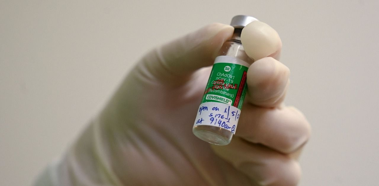 A medical worker holds a vial of the Covishield Covid-19 vaccine. Credit: AFP Photo