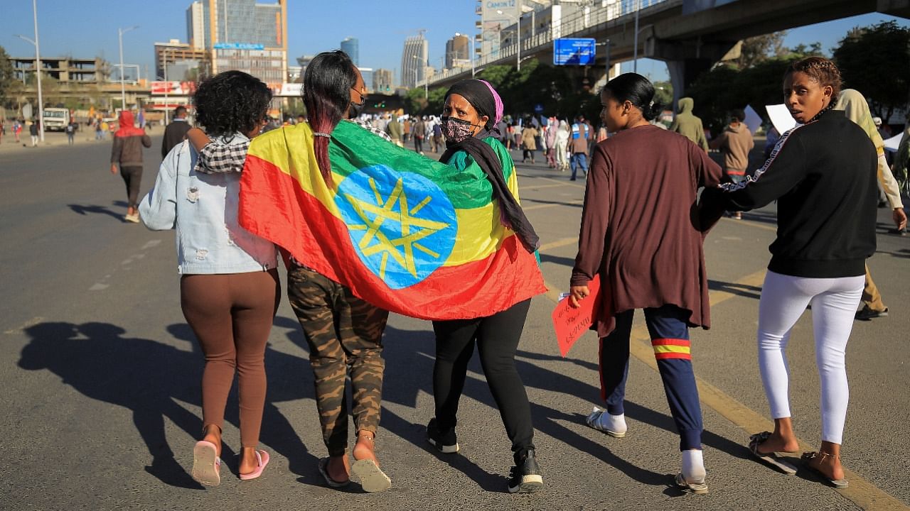 Pro-government demonstrators hold their national flag as they attend a rally to protest against the US action over alleged human rights abuses during the conflict in the Tigray region, in Addis Ababa. Credit: Reuters Photo