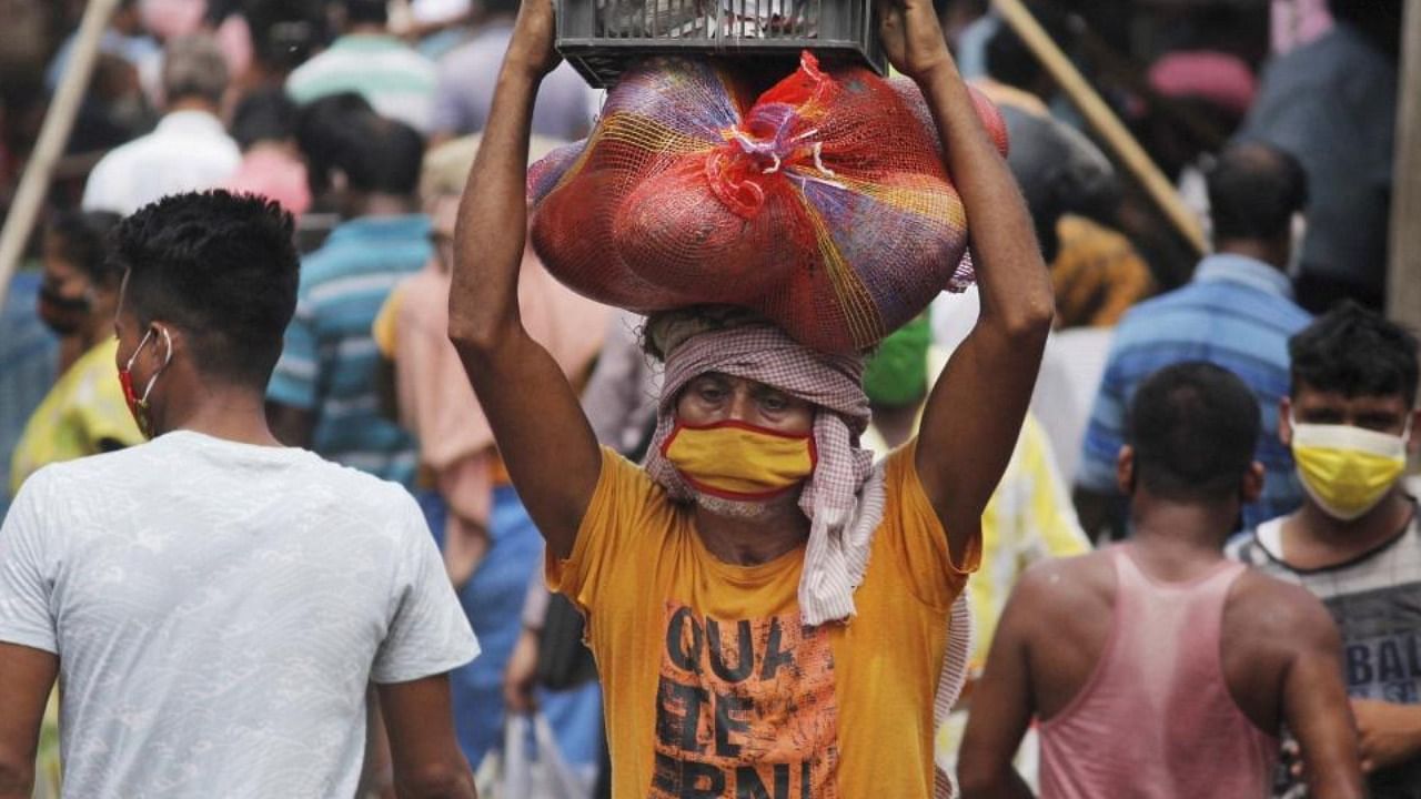 An over-crowded market place during a relaxation in Covid-19 restrictions, in Agartala, Saturday, May 29, 2021. Credit: PTI Photo