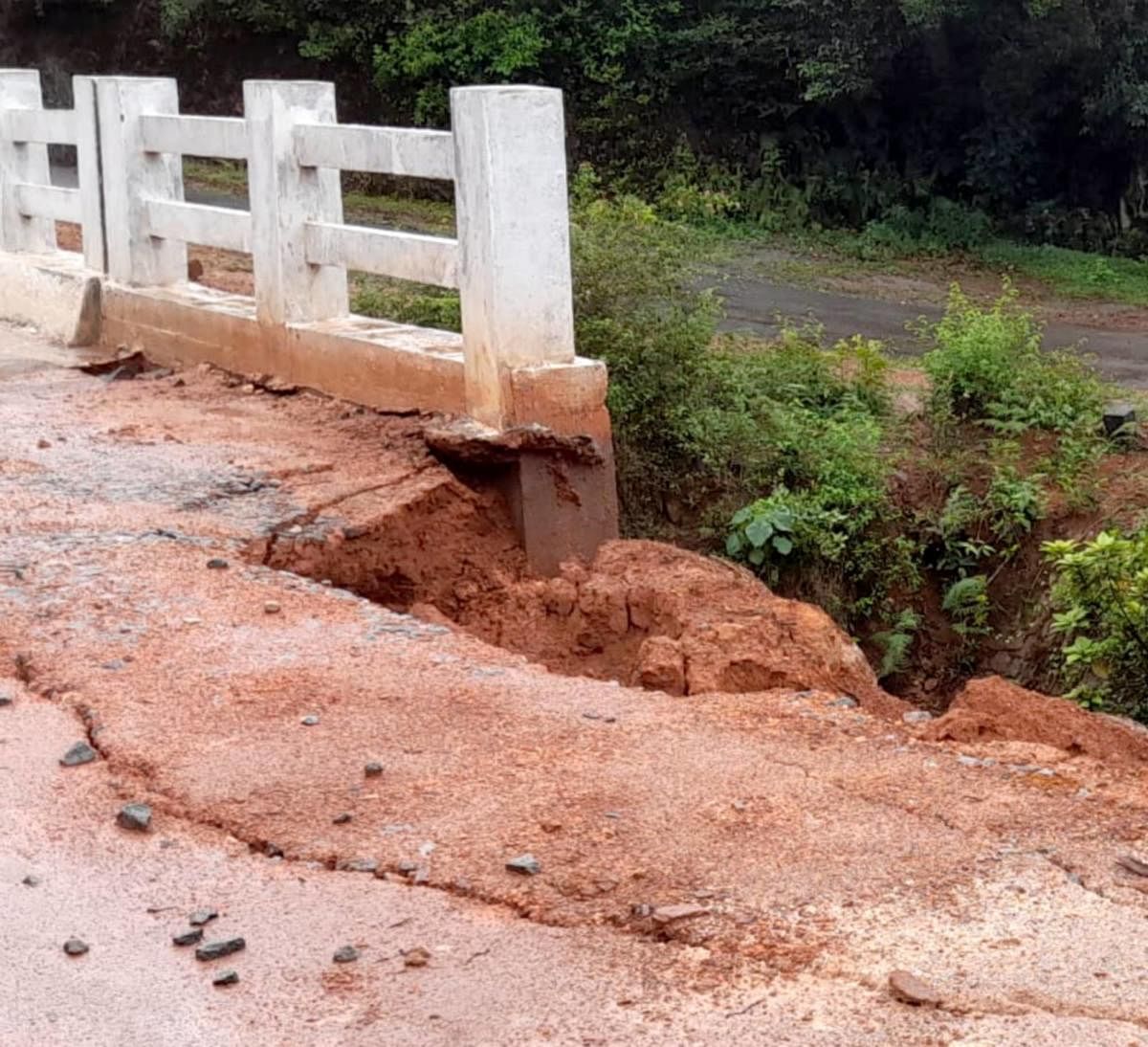 The soil dumped by the side of the bridge in Haraga has caved in and entered the water body that flows below.