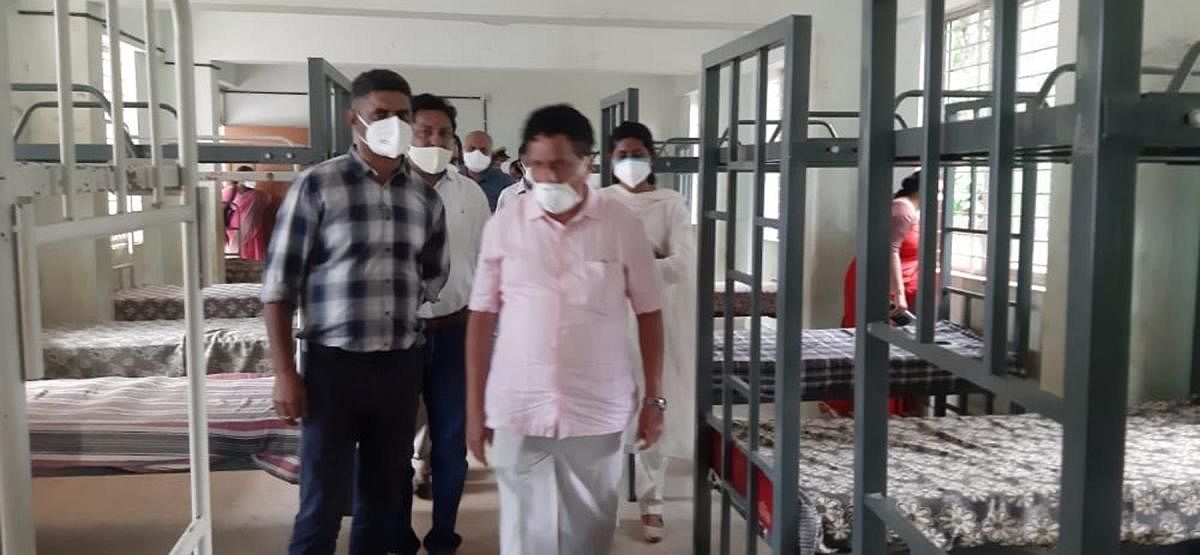 MLA K G Bopaiah inspects the beds arranged for Covid-19 infected at Ashrama School in Thithimathi Maroor.