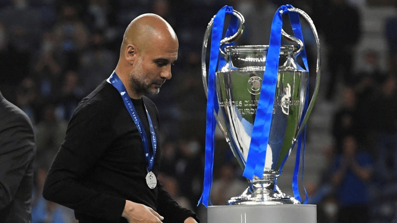 Manchester City manager Pep Guardiola walks past the Champions League trophy after the match. Credit: Reuters Photo