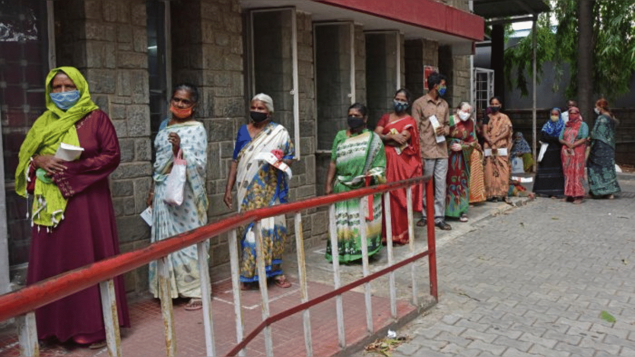 Senior citizens queue up in front of a post office for pension in Bengaluru. Credit: DH File Photo