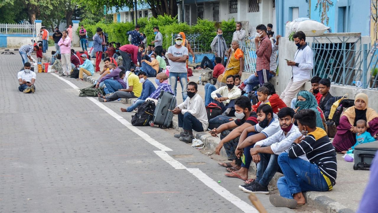 Migrant labourers wait for trains to reach their work destinations, amid the second wave of Covid-19 pandemic, outside Hatia railway station in Ranchi, Monday, May 31, 2021. Credit: PTI Photo