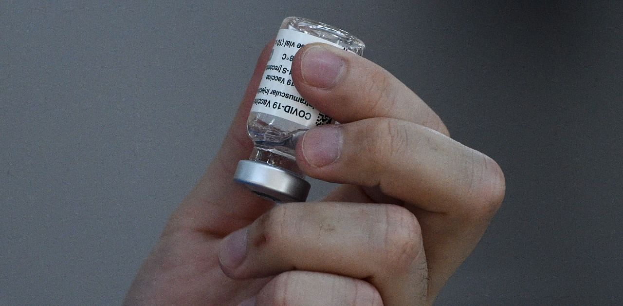 A health worker holds a vial of the AstraZeneca/Oxford Covid-19 vaccine. Credit: AFP Photo