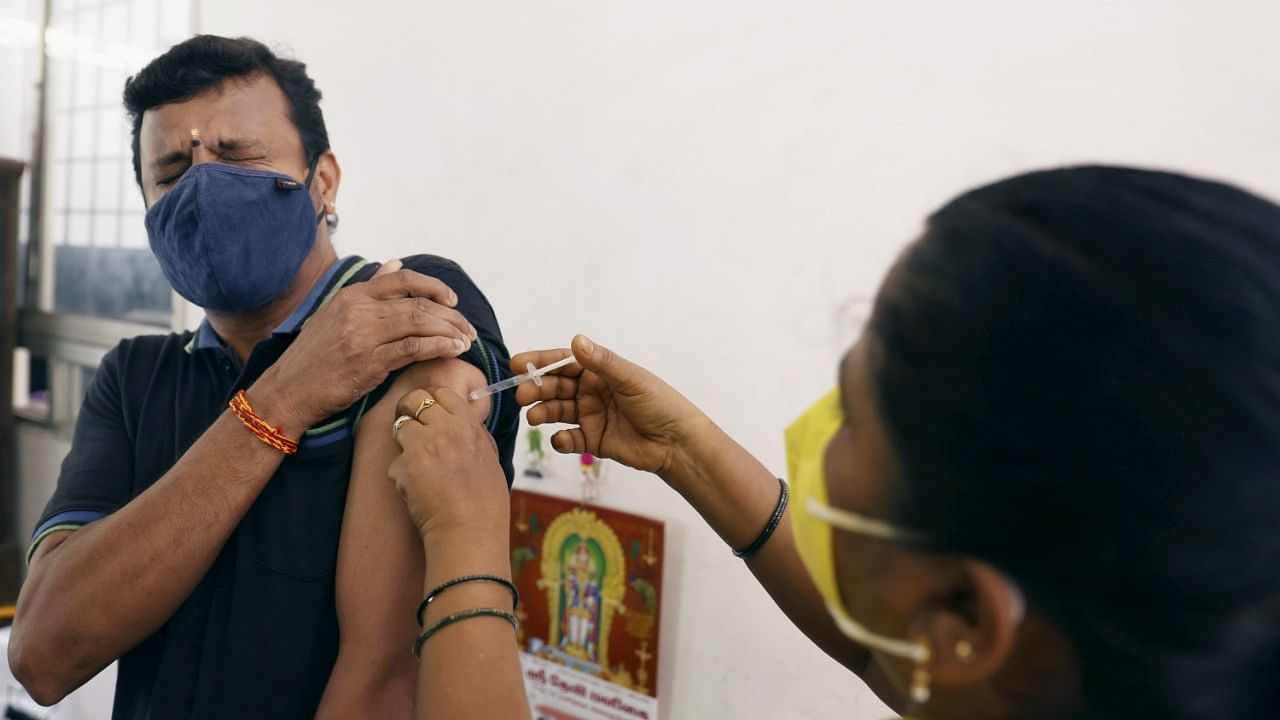 A medic inoculates a dose of the Covid-19 vaccine to a beneficiary, at Raja street Health center, in Coimbatore, Tuesday, June 01, 2021. Credit: PTI Photo