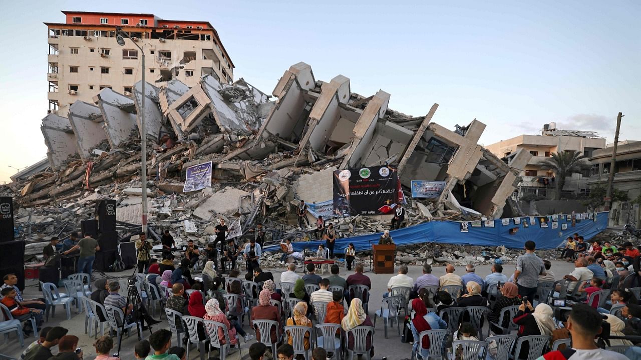Palestinian musicians perform on the rubble of the Hanadi Tower during an event organised by the Palestinian Committee for Youth and Culture in Gaza City on June 2, 2021, more than a week after a ceasefire brought an end to 11 days of hostilities between Israel and Gaza rulers Hamas. Credit: AFP Photo