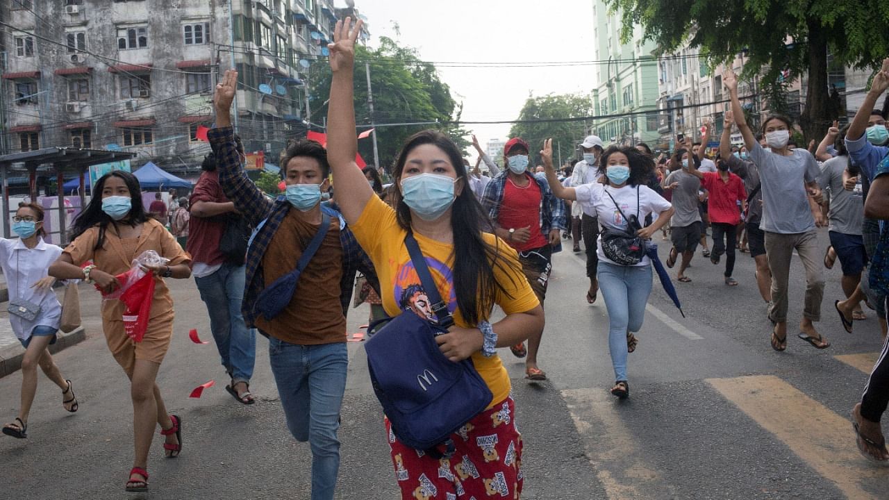Anti-coup protesters flash the three-finger salute during a flash mob protest in Yangon, Myanmar June 3, 2021. Credit: Reuters Photo