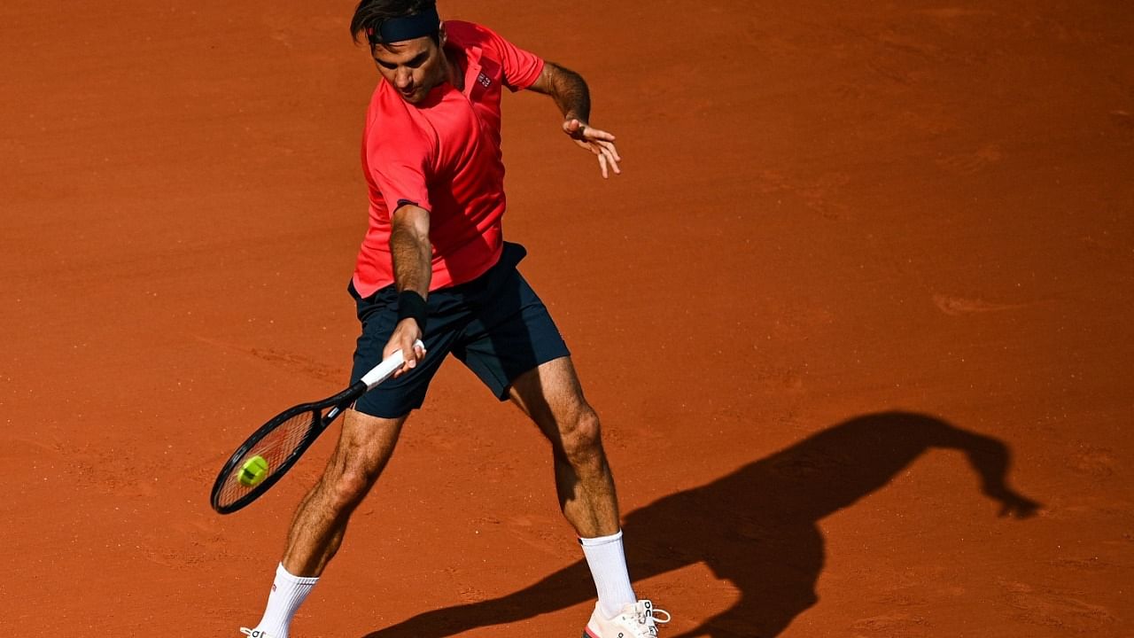 Switzerland's Roger Federer returns the ball to Croatia's Marin Cilic during their men's singles second round tennis match on Day 5 of The Roland Garros 2021 French Open tennis tournament in Paris. Credit: AFP Photo