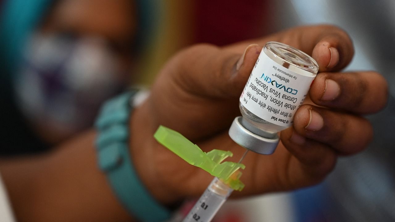A health worker prepares a dose of the Covaxin Covid-19 vaccine. Credit: AFP File Photo