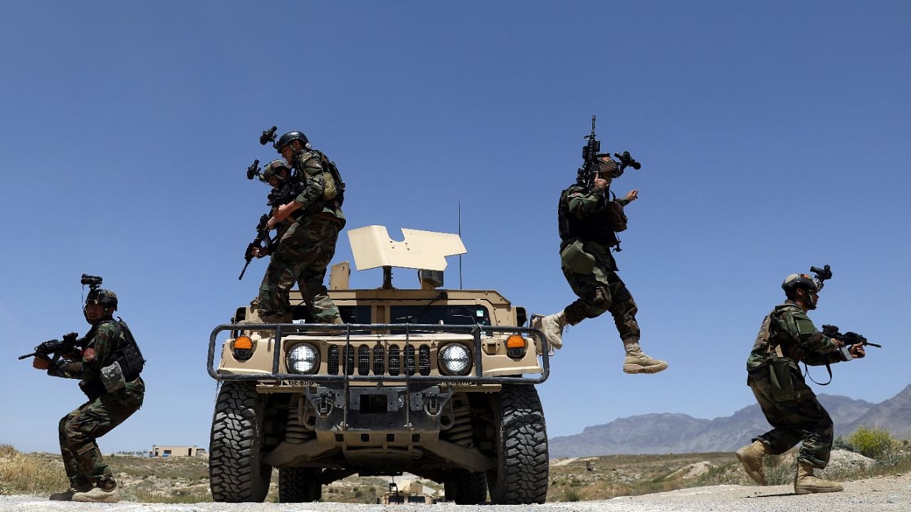 Afghan soldiers patrol outside their military base. Credit: AP Photo